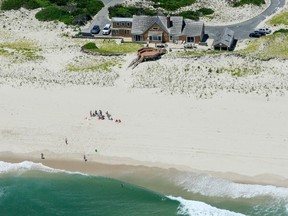 In this Sunday, July 2, 2017, photo, New Jersey Gov. Chris Christie uses the beach with his family and friends at the governor's summer house at Island Beach State Park in New Jersey. (Andrew Mills/NJ Advance Media via AP)