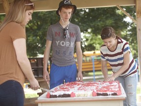Here is the massive Canada 150 cake. Alex Bachert, Colton Bachert and Taylor Malone helped cut the cake. (Shaun Gregory/Huron Expositor)