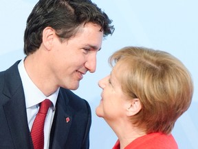 Prime Minister Justin Trudeau greets German Chancellor Angela Merkel at the official welcoming ceremony at the G20 summit Friday, July 7, 2017 in Hamburg, Germany. (Ryan Remiorz/THE CANADIAN PRESS)