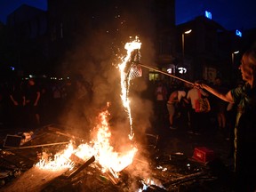 Demonstrators burn the United States flag during an anti-G20 protest on July 7, 2017 in Hamburg, Germany. (Photo by Alexander Koerner/Getty Images)