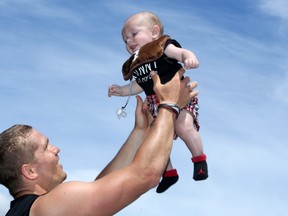 Redblacks quarterback Trevor Harris clearly dotes on his five-month-old son, Trenton, seen here with his dad following practice at TD Place on June 21, 2017. (Julie Oliver/Postmedia)