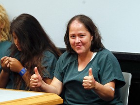 Isabel Martinez gestures towards news cameras during her first court appearance Friday, July 7, 2017, in Lawrenceville , Ga. (AP Photo/John Bazemore)