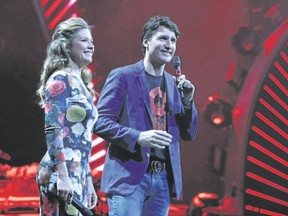 Justin Trudeau and Sophie Gregoire-Trudeau speak at the Global Citizen Festival G20 benefit concert on the eve of the G20 summit, where Green Party Leader Elizabeth May says he needs to step up on climate change. (RONNY HARTMANN/AFP)
