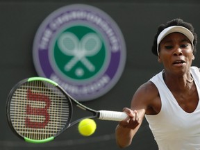 Venus Williams of the United States returns to Japan's Naomi Osaka during their Women's Singles Match on day five at the Wimbledon Tennis Championships in London Friday, July 7, 2017. (AP Photo/Kirsty Wigglesworth)