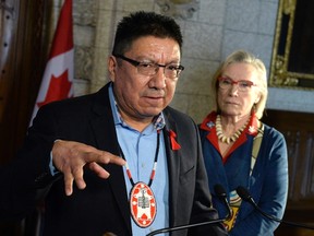 Nishnawbe Aski Nation Grand Chief Alvin Fiddler speaks to reporters as Indigenous and Northern Affairs Minister Carolyn Bennett looks on during a press conference on Parliament Hill, Friday, March 10, 2017 in Ottawa. (Justin Tang/THE CANADIAN PRESS)
