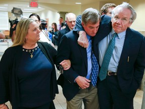 Shannon Kepler walks with his wife, Gina, while his attorney, Richard O’Carroll, puts his arm around him after a hung jury verdict was announced at the Tulsa Country Courthouse, Friday, July 7, 2017, in Tulsa, Okla. (Ian Maule/Tulsa World via AP)