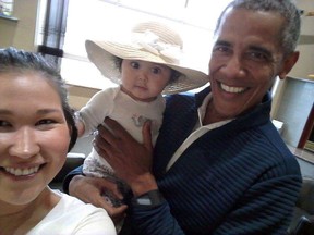 In this July 3, 2017 photo provided by Jolene Jackinsky, former U.S. President Barack Obama holds Jackinsky’s 6-month-old baby girl while posing for a selfie with the pair at a waiting area at Anchorage International Airport, in Anchorage, Alaska. (Jolene Jackinsky via AP)