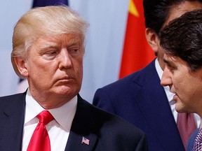 U.S. President Donald Trump talks with Prime Minister Justin Trudeau during the Women's Entrepreneurship Finance event at the G20 Summit in Hamburg, Germany, Saturday, July 8, 2017. (AP Photo/Evan Vucci)