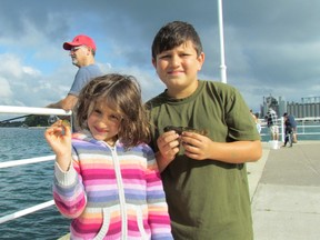 Brother and sister Nicole Clarkson, 7, and Nolan Clarkson, 9, of Sarnia hold up gobies they reeled in Saturday July 8, 2017 during the Bluewater Anglers Family Fun Day held in Centennial Park in Sarnia, Ont.