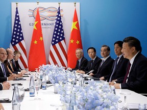 U.S. President Donald Trump, second left, meets Chinese President Xi Jinping, right, at the G20 Summit, Saturday, July 8, 2017, in Hamburg, Germany. (AP Photo/Evan Vucci)