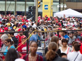 Thousands of people wait to make their way through security checks on Elgin Street near Wellington Street during Canada Day celebrations in downtown Ottawa on July 1.