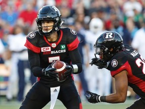 Ottawa Redblacks quarterback Trevor Harris (7) fakes handing the ball off to running back Mossis Madu Jr. (23) during the first half of CFL football action against the Toronto Argonauts in Ottawa on Saturday, July 8, 2017. (Patrick Doyle/THE CANADIAN PRESS)