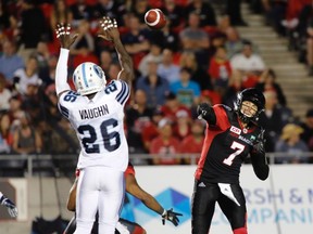 Argonauts defensive back Cassius Vaughn tries to block a pass by Ottawa Redblacks quarterback Trevor Harris during last night’s game. (THE CANADIAN PRESS)