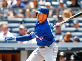 Justin Smoak #14 of the Toronto Blue Jays follows through on a first inning RBI base hit against the New York Yankees at Yankee Stadium on July 5, 2017 in the Bronx borough of New York City. (Photo by Jim McIsaac/Getty Images)