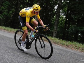 Britain's Chris Froome, wearing the overall leader's yellow jersey, speeds downhill during the ninth stage of the Tour de France cycling race over 181.5 kilometers with start in Nantua and finish in Chambery, France, Sunday, July 9, 2017. (AP Photo/Christophe Ena)