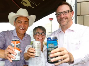 L-R, Joe Ceci, President of Treasury Board and Minister of Finance toasts with Calgary Councillor, Druh Farrell and Terry Rock, Executive Director of the Alberta Small Brewers Association after announcing a new policy to make it easier for licensed venues in Alberta to have greater control over the size of their patios and fewer restrictions on how they are built at the King Eddy in Calgary on Sunday July 9, 2017. DARREN MAKOWICHUK/Postmedia Network