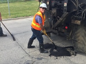 Coun. Marty Morantz (Charleswood-Tuxedo-Whyte Ridge) helps out a street patching crew tackle one of Winnipeg's many potholes. Morantz announced on Twitter on Friday, July 7, 2017, that the city has filled nearly 100,000 potholes since the beginning of the year including more than 3,600 since June 30. Morantz has been posting his weekly Pothole Updates since April, 2017. Submitted photo