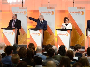 Guy Caron, left, Charlie Angus, Niki Ashton and Peter Julian react to the audience as they arrive on stage for the first debate of the federal NDP leadership race, in Ottawa on Sunday, March 12, 2017. THE CANADIAN PRESS/Justin Tang