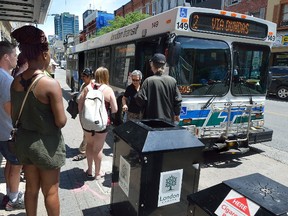 Passengers wait to board a London Transit Commission bus on Dundas at Richmond streets. The LTC is in the midst of hiring about 34 new drivers. (MORRIS LAMONT, The London Free Press)