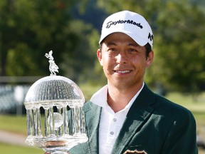 Xander Schauffele holds the winners trophy on the 18th green after winning the Greenbrier Classic PGA Tour golf tournament, Sunday, July 9, 2017, in White Sulphur Springs, W.Va. Schauffele shot a 3-under to finish the tournament at 14-under-par. (AP Photo/Steve Helber)