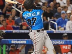 Vladimir Guerrero Jr. #27 of the Toronto Blue Jays and the World Team swings at a pitch against the U.S. Team during the SiriusXM All-Star Futures Game at Marlins Park on July 9, 2017 in Miami, Florida. (Photo by Mike Ehrmann/Getty Images)