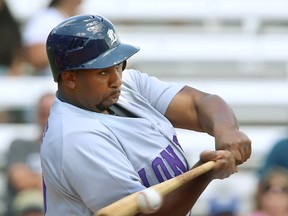 Cleveland Brownlee, designated hitter for the Majors, connects for a single Sunday on his first pitch of their doubleheader against the unbeaten Barrie Baycats at Labatt Park. The Majors wore their purple uniforms as part of their campaign to raise money for the Shine the Light on Woman Abuse campaign.  (Mike Hensen/The London Free Press)