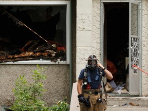 Edmonton Fire Rescue Services firefighters investigate a blaze in a home at 11612 88 Street in Edmonton on Sunday, July 9, 2017. Ian Kucerak / Postmedia