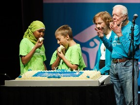Former US President Jimmy Carter (right) and former first lady Rosalynn Carter (second from right) cut a celebratory cake with children who will move into Habitat for Humanity homes during the opening ceremony for the 34th Jimmy and Rosalynn Carter Work Project at the Shaw Conference Centre in Edmonton on Sunday, July 9, 2017. Ian Kucerak / Postmedia