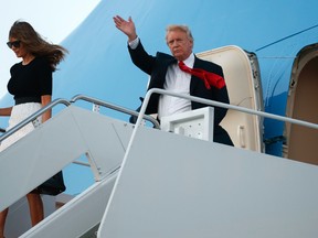 U.S. President Donald Trump waves as he and first lady Melania Trump arrive at Andrews Air Force Base, Saturday, July 8, 2017, in Andrews Air Force Base, Md. (AP Photo/Evan Vucci)