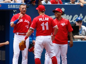 Toronto Blue Jays Kevin Pillar CF (11) is congratulated by Marcus Stroman and Troy Tulowitzki after snaring a line shot  in the first inning in Toronto, Ont. on Sunday July 9, 2017. Jack Boland/Toronto Sun/Postmedia Network