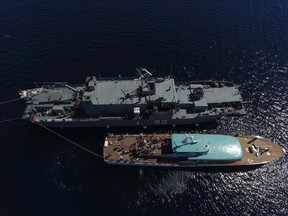 In this photo taken Saturday, July 8, 2017, provided by Croatian Defense Ministry, Croatian Navy ships are anchored in the waters near the Adriatic island of Vis. Divers have located human bones near the wreckage of a U.S. bomber that crashed in the Adriatic Sea in Croatia in 1944. The discovery was made last week at the site of the crash of The Tulsamerican, the last B-24 Liberator bomber built in Tulsa, Oklahoma, near the end of World War II. (Croatian Ministry of Defense via AP)