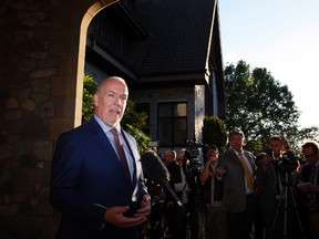 NDP leader and Premier-designate John Horgan makes a brief statement and answers questions from the media after meeting with Lt.-Gov. Judith Guichon at the Government House in Victoria, B.C., on Thursday, June 29, 2017. THE CANADIAN PRESS/Chad Hipolito