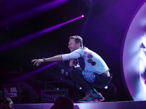 Chris Martin (R) from Coldplay performs on stage during the Global Citizen Festival G20 benefit concert at the Barclaycard Arena in Hamburg, northern Germany on July 6, 2017 on the eve of the G20 summit. (RONNY HARTMANN/AFP/Getty Images)