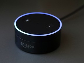 This Wednesday, March 2, 2016 photo shows an Echo Dot in San Francisco. Amazon.com is introducing two devices, the Amazon Tap and Echo Dot, that are designed to amplify the role that its voice-controlled assistant Alexa plays in people's homes and lives. (AP Photo/Jeff Chiu)