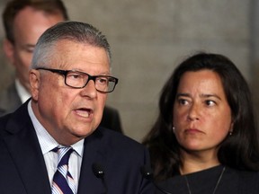 Ralph Goodale (left), Minister of Public Safety and Emergency Preparedness, and Jody Wilson-Raybould, Minister of Justice and Attorney General of Canada, hold a news conference regarding a $10.5-millon payment to Omar Khadr on Parliament Hill in Ottawa on Friday, July 7, 2017. THE CANADIAN PRESS/Fred Chartrand
