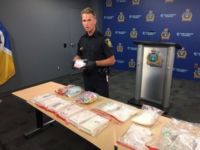 Winnipeg Police Service spokesperson Const. Jay Murray displays various amounts of cocaine, crack cocaine, and methamphetamine from a large drug bust carried out on Friday, July 7, 2017, at a media briefing at police headquarters in Winnipeg on Monday, July 10, 2017. JASON FRIESEN/Winnipeg Sun/Postmedia Network
