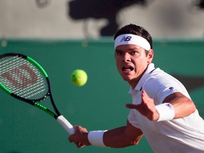 Canada’s Milos Raonic returns against Germany’s Alexander Zverev during the 2017 Wimbledon Championships at The All England Lawn Tennis Club in Wimbledon on July 10, 2017. (DANIEL LEAL-OLIVAS/Getty Images)