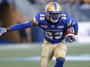Winnipeg Blue Bombers' TJ Heath (23) runs the ball after an interception against the Calgary Stampeders during the first half of CFL action in Winnipeg Friday, July 7, 2017. THE CANADIAN PRESS/John Woods