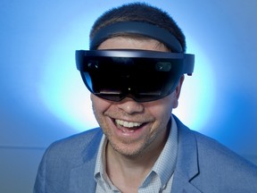 Mark Mikulec wears a Microsoft HoloLens mixed reality headset in London, Ont. on Monday, July 10, 2017. His company, Joydrop is creating software that when combined with a HoloLens, will turn your living room into a video game. (DEREK RUTTAN, The London Free Press)