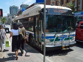 Passengers wait to board a London Transit bus on Dundas Street at Richmond on Thursday, July 6, 2017. (MORRIS LAMONT, The London Free Press)