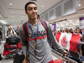 Kanata's Noah Kirkwood arrives at Toronto's Pearson Airport on Monday evening with other members of Canada's under-19 basketball team after winning gold at the U19 FIBA World Cup at Cairo on Sunday.