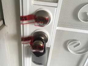 Red evidence tape covers part of the door leading to the condo where Ikaika Kang, a sergeant first class in the U.S. Army, lives in Waipahu, Hawaii, Monday, July 10, 2017. (AP Photo/Jennifer Sinco Kelleher)