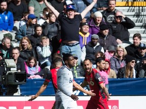 Toronto FC's Victor Vazquez, back right, celebrates his goal as Vancouver Whitecaps' Sheanon Williams, front, looks on during second half MLS soccer in Vancouver, B.C., on Saturday, March 18, 2017. THE CANADIAN PRESS/Darryl Dyck