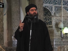 This file image grab taken from a propaganda video released on July 5, 2014 by al-Furqan Media allegedly shows the leader of the Islamic State (IS) jihadist group, Abu Bakr al-Baghdadi, aka Caliph Ibrahim, adressing Muslim worshippers at a mosque in the militant-held northern Iraqi city of Mosul. (AFP/GETITY IMAGES/AL-FURQAN MEDIA/HO)