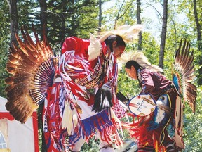 Two Native dancers from the Sunchild reserve perform onstage during a break between the arrival of the voyageurs and sprint races held during the afternoon of July 2 at Willey West campground.