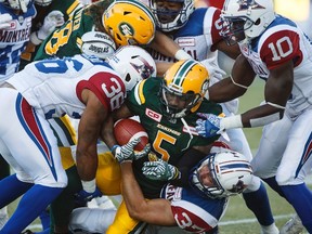 Montreal Alouettes' Martin Bedard (37) takes down Edmonton Eskimos' Travon Van (5) during first half CFL action in Edmonton on Friday, June 30, 2017.