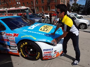 Alex Tagliani pushes his EpiPen car around for a promotion in Toronto on Thursday August 28, 2014. (Postmedia Network file photo)