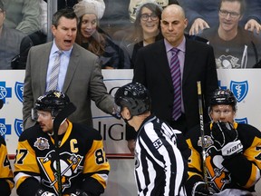 Pittsburgh Penguins assistant coach Rick Tocchet (right) listens to Mike Sullivan yell at linesman Brian Murphy during a game against the Arizona Coyotes in Pittsburgh, Monday, Dec. 12, 2016. (AP Photo/Gene J. Puskar)