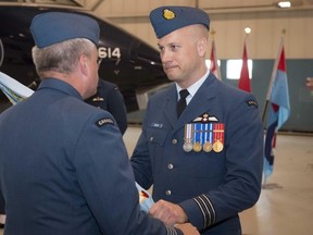 Cpl. Michael J. MacIsaac/Canadian Forces Support Unit
Incoming 412 Squadron commanding officer Lt.-Col. David Snow, right, receives the squadron's colours from Col. Colin Keiver at a ceremony Tuesday in Ottawa.