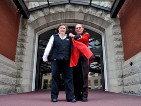 Longtime Delta London Armouries doorman Gary Johnston helps daughter Cindy Steele into a red uniform jacket at the downtown London hotel. Johnston has been a fixture there for nearly 25 years, but is handing off many of his duties to Cindy. (CHRIS MONTANINI, Londoner)